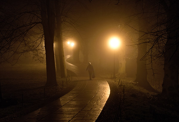 dark foggy path winding out of King's College at Cambridge University in England